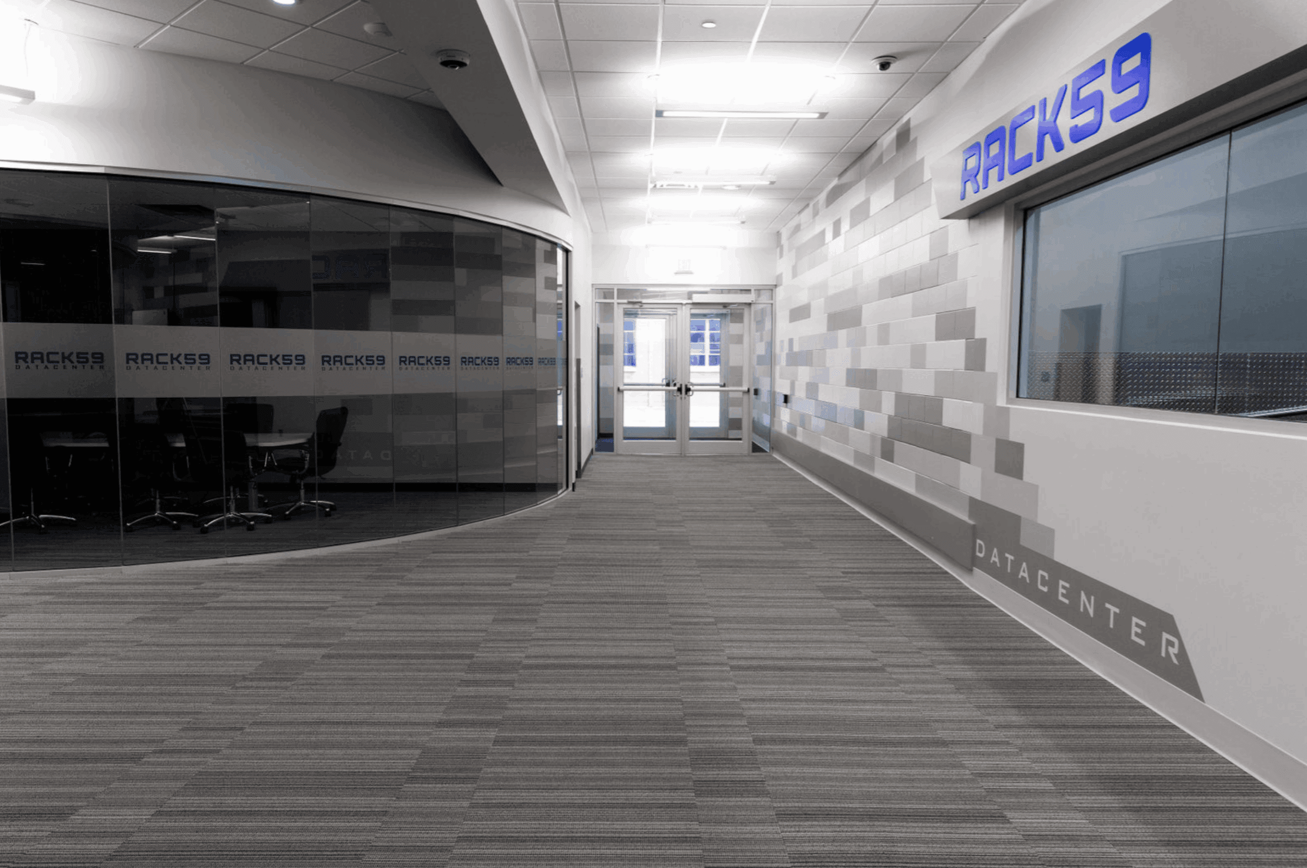 The sleek, modern entry corridor of the RACK59 Data Center, featuring a secure, professional environment with branded conference rooms and high-tech infrastructure